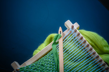 loom with greenwool for felting