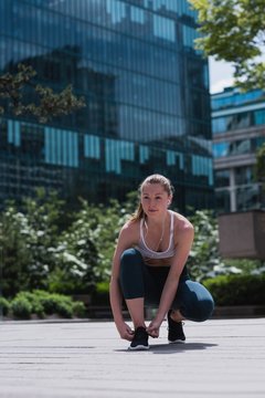 Sporty woman tying shoe laces