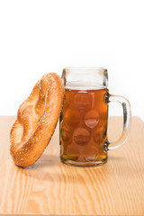 selective focus of beer with pretzel on wooden table on white background