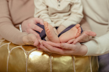 Feet of new born Baby in Hands of parents