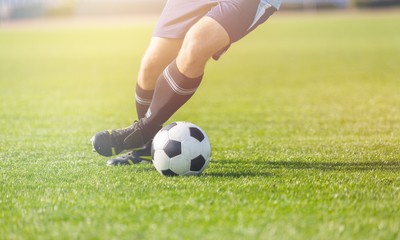 Running soccer player on grass