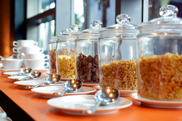 cereal cornflakes in a glass jar on buffet table