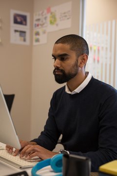 Male executive working on computer at desk