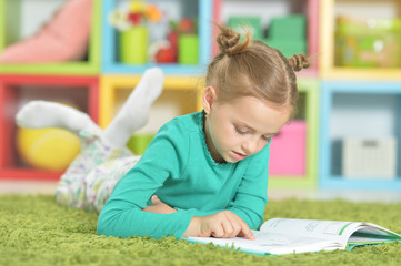 Portrait of a cute happy schoolgirl studying