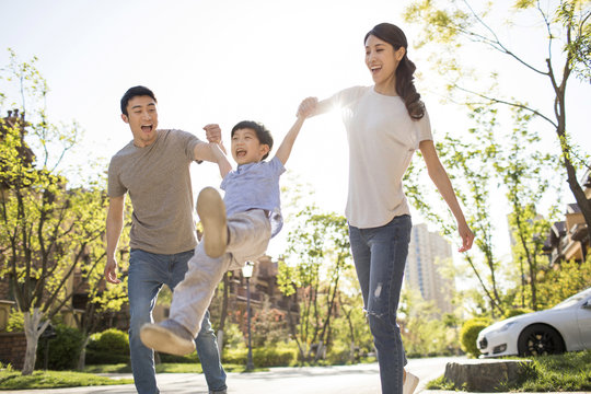 Happy young family playing outdoors