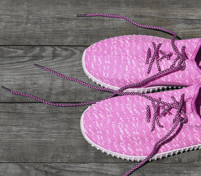 pink textile shoes with untied laces