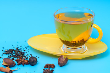 Stylish yellow cup of spiced herbal tea