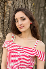 Portrait of a beautiful girl in the summer in the forest	