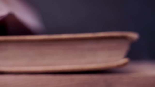 Books on an old wooden table. Beautiful dark background.