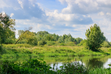 River landscape on a background of blue sky with clouds at sunny summer day