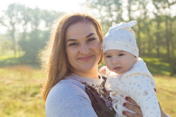 Happy mother with the child in the field	