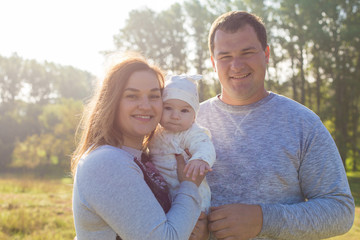 Happy family with the child in the field	