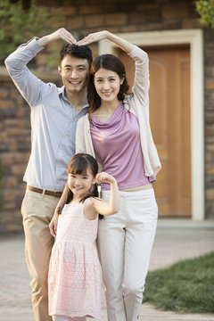 Happy young family holding keys to new house