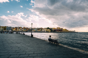 Fototapeta premium Panorama venetian harbour waterfront and Lighthouse in old harbour of Chania at sunset, Crete, Greece