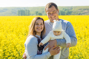 Happy family with the child in the field