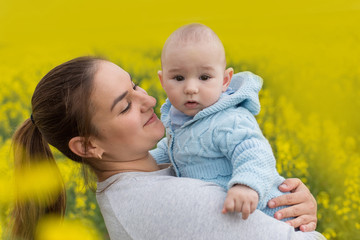 Happy mother with the child in the field	