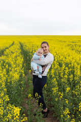 Fototapeta premium Happy mother with the child in the field 