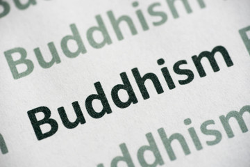 word Buddhism printed on paper macro