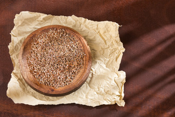 Organic linseed seeds in the wooden bowl