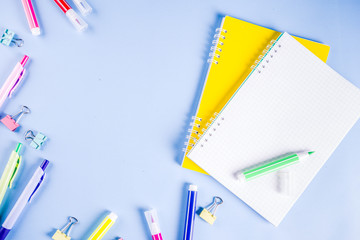 Back to school background, with bright accessories supplies for school and study - pen, pencils, markers, pencils, rulers, paperclips, sticks, notebooks, top view, free copy space for text