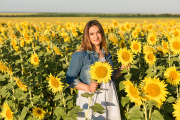 Pregnant girl in sunflowers, happy girl waiting for the baby