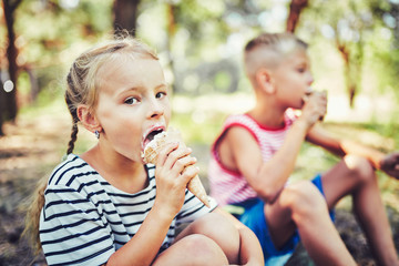 Fototapeta premium Kids eating ice cream on hot summer day on tropical vacation.
