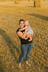 Mother with child in wheat