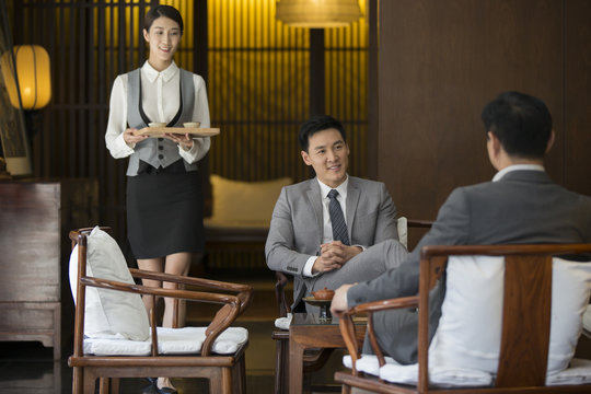 Cheerful businessmen talking in tea room