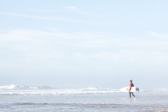 Surfer entering water