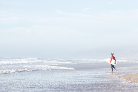 Surfer entering water
