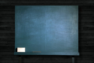 empty green blackboard on wooden wall in classroom for education background.