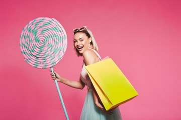 Model posing with with sweets and shopping bags