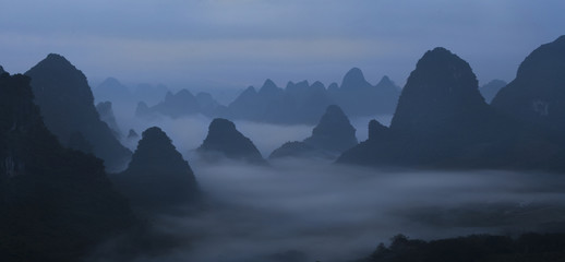Fototapeta na wymiar Chinese mountains in the mist and fog