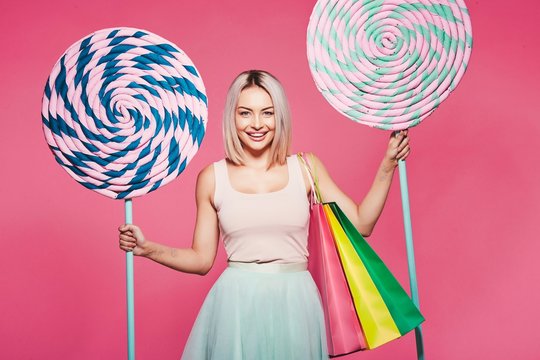 Model posing with with sweets and shopping bags
