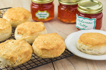 Fresh baked buttermilk biscuits and glass jars with habanero jelly.