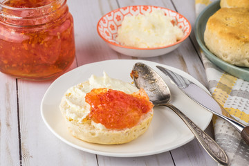 Biscuit sandwich with butter spread and habanero jelly.