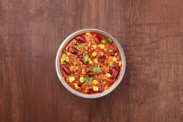 Chili con carne, traditional Mexican dish, overhead photo with copyspace