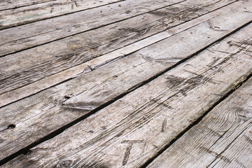 White boardwalk of stripped weathered washed out wooden planks with scratches. Abstract natural texture background