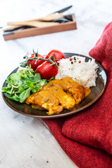 Rice and chicken on white plate