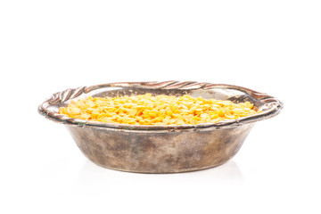 Lot of whole raw red lentils in old iron bowl isolated on white background