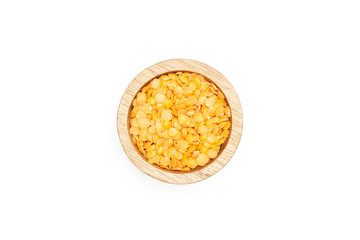 Lot of whole raw red lentils with wooden bowl flatlay isolated on white background