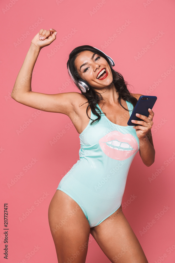 Sticker Woman in swimwear using mobile phone listening music with headphones.