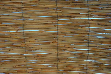 Stylish gold, yellow bars, banded sticks and straw sticks against the blue sky