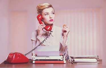 Attractive young woman speaking on  vintage phone