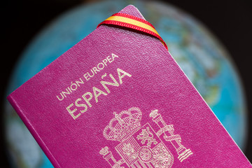 Spanish passport and earth globe, travel around the world concept