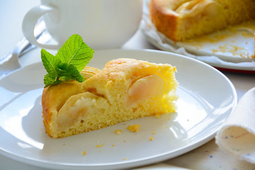 Slice of homemade apple pie on white plate. Tea time concept