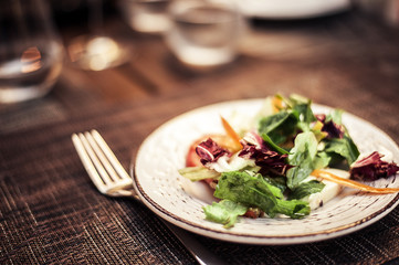 appetizer - salad with tomato and cucumber on white plate