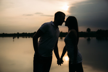 Fototapeta premium Silhouette of beautiful couple. lake in background