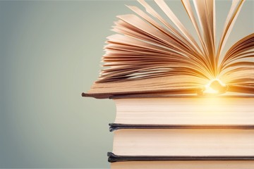 Old stacked books on background