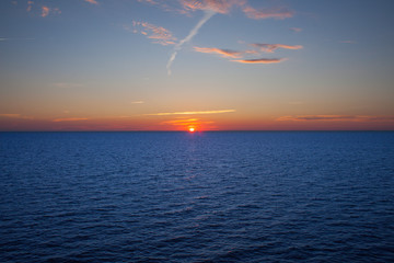 Sunset at the sea. Natural landscape blue ocean and blue sky with clouds